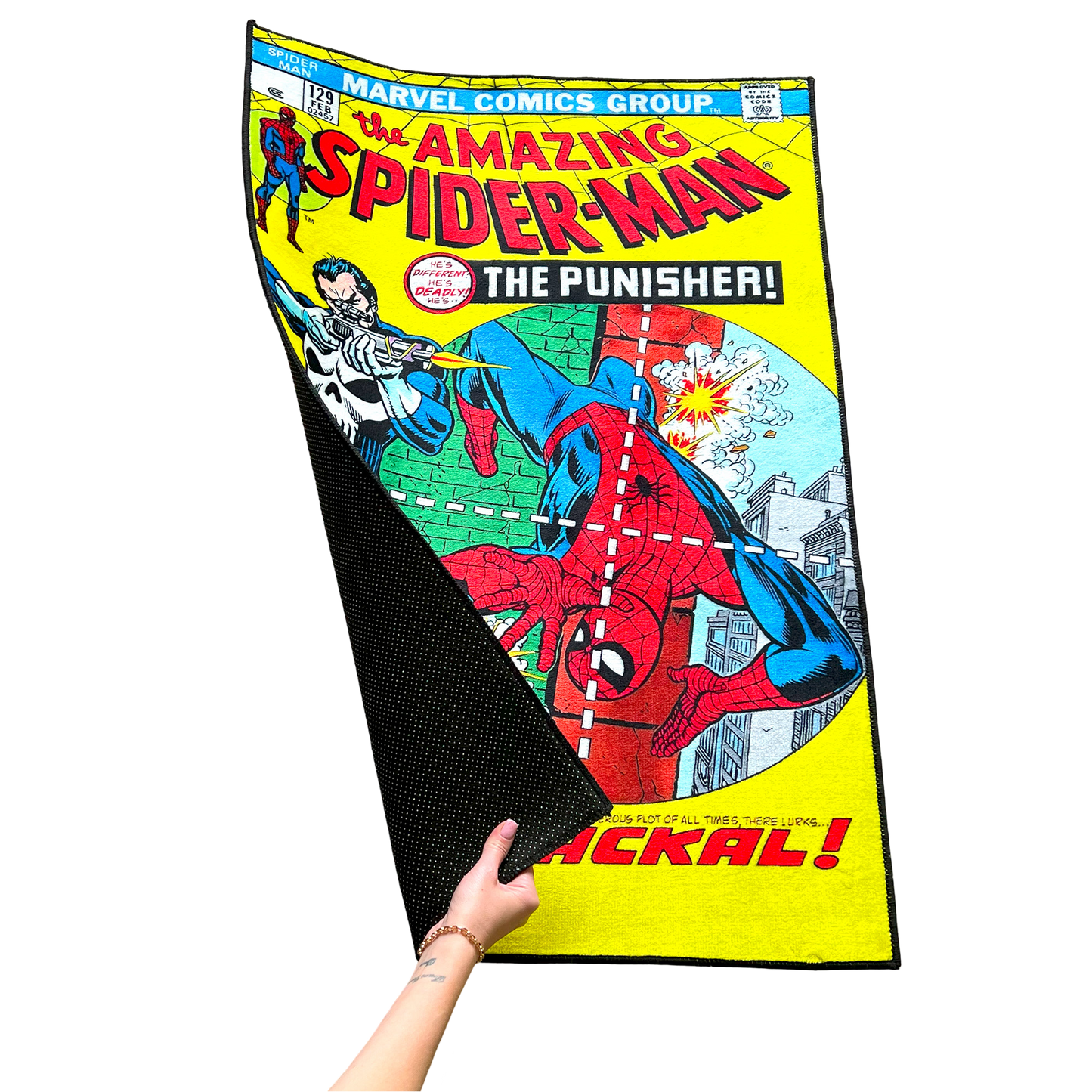 Close-up of a Punisher vs. Spider-Man rug with a hand lifting the corner, showing the smooth texture and flexible, high-quality material.