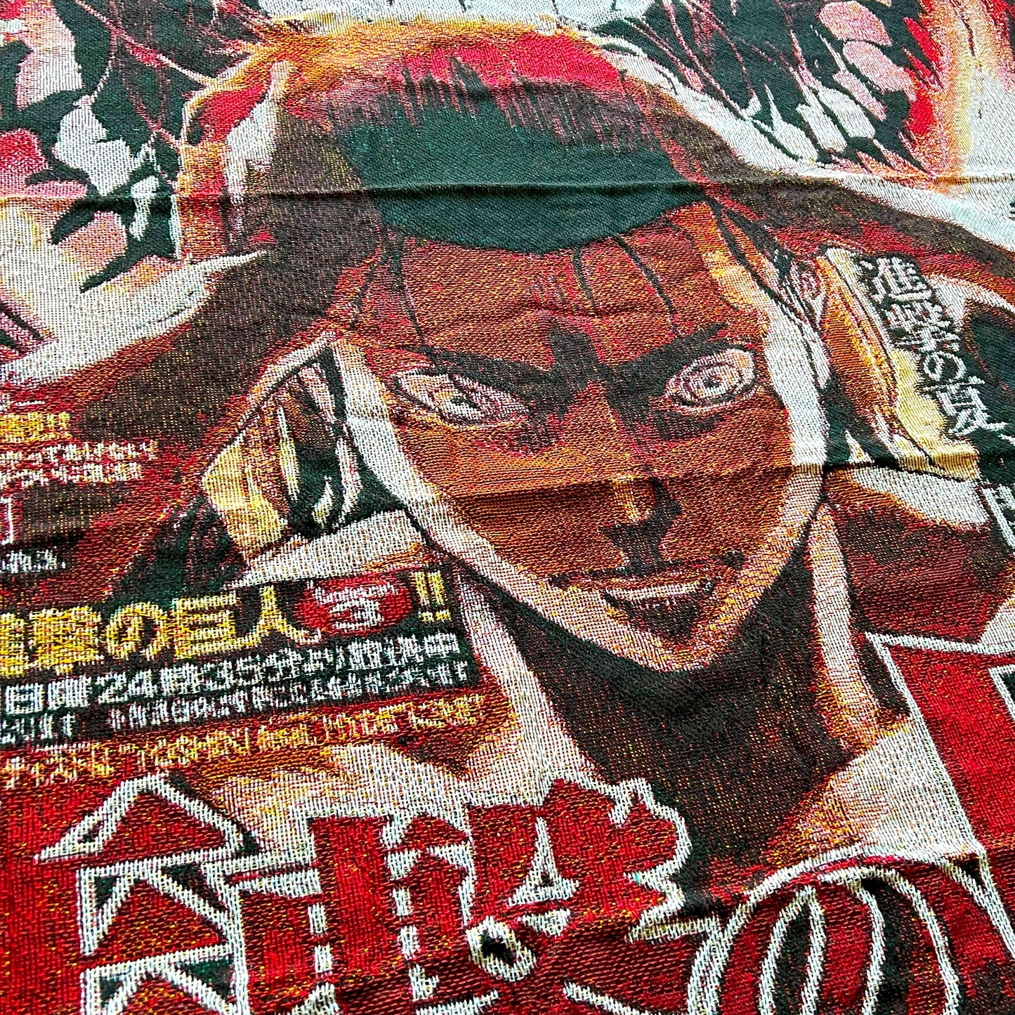 Extreme close-up of an Attack on Titan tapestry showing the fine woven texture and sharp details of Eren Yeager’s character design.