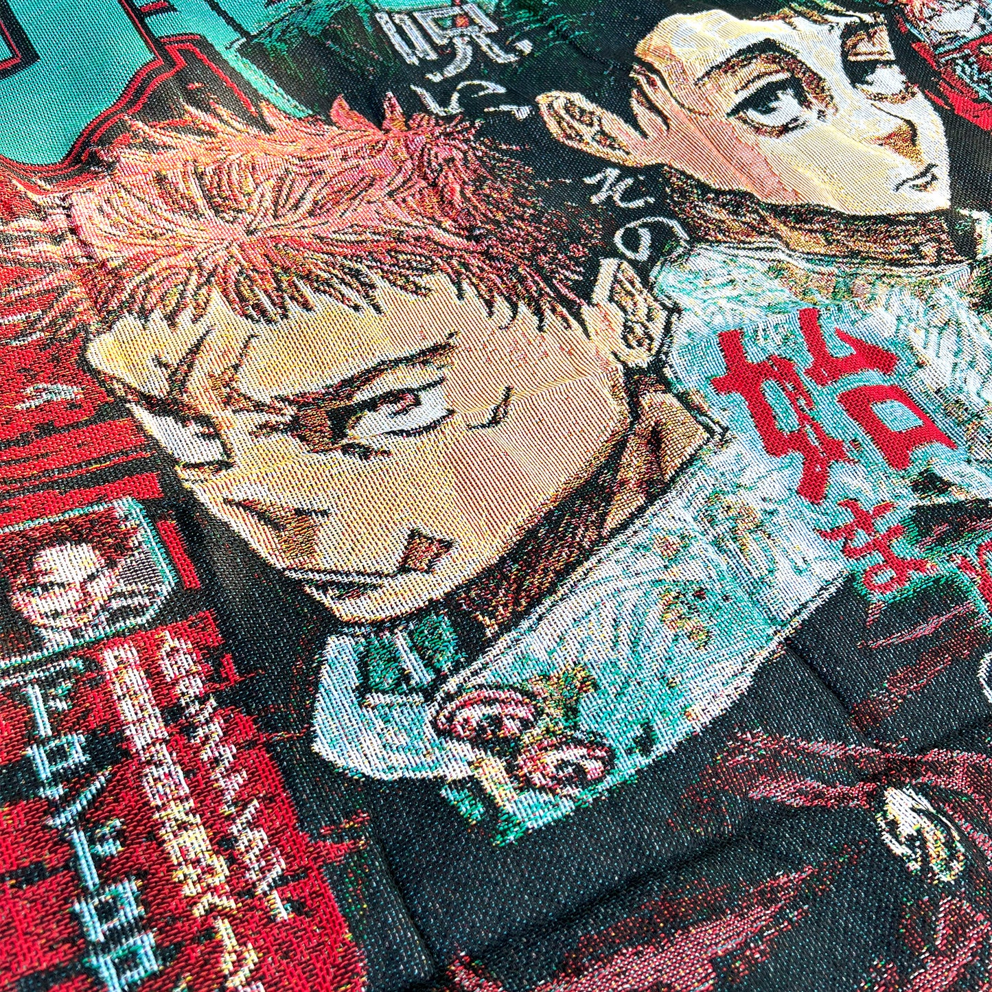 Close-up side view of a Jujutsu Kaisen tapestry highlighting the detailed textures and expressive artwork of Itadori and Yuta.