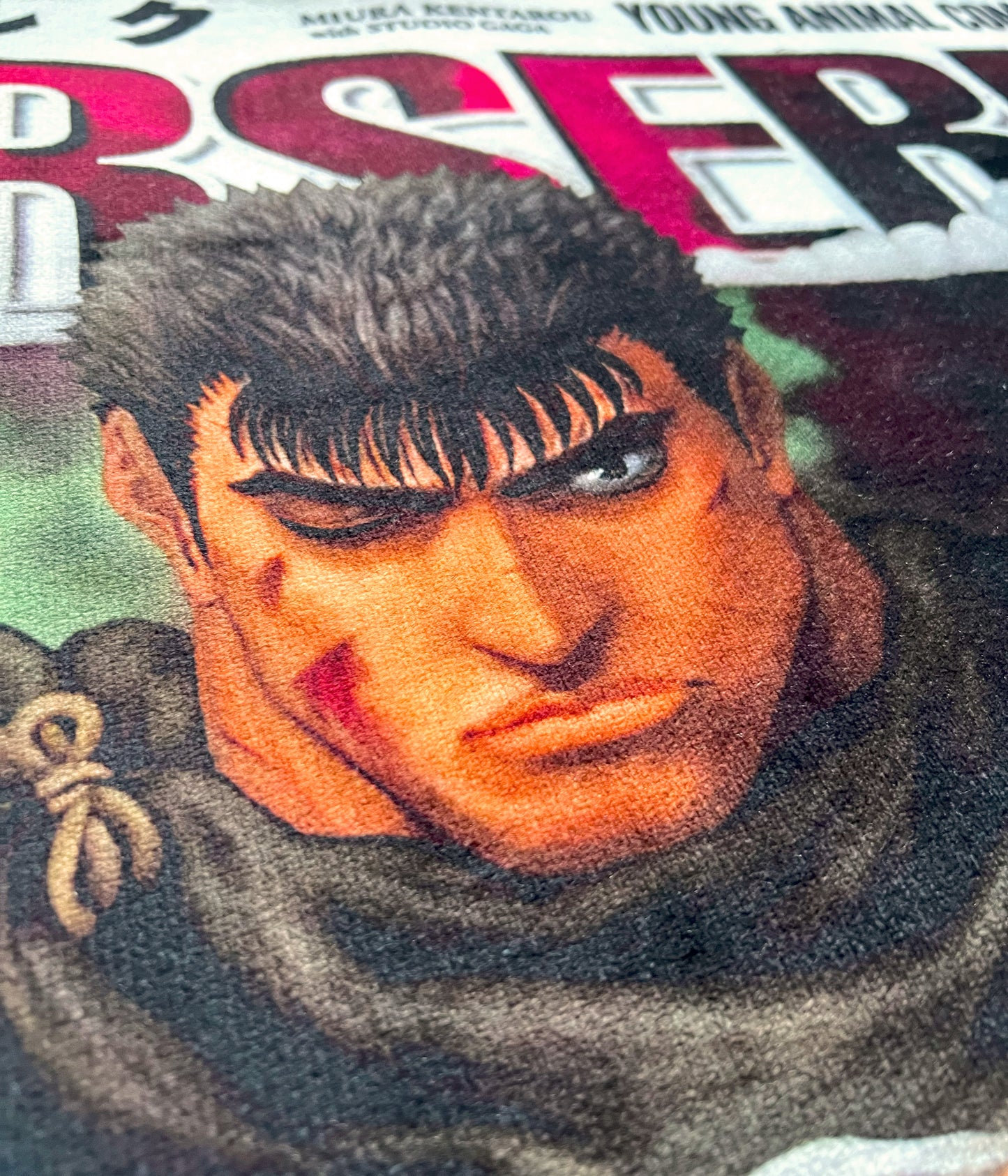 Close-up side view of a Berserk Guts rug highlighting the intricate details and dramatic contrasts of the iconic character’s design.