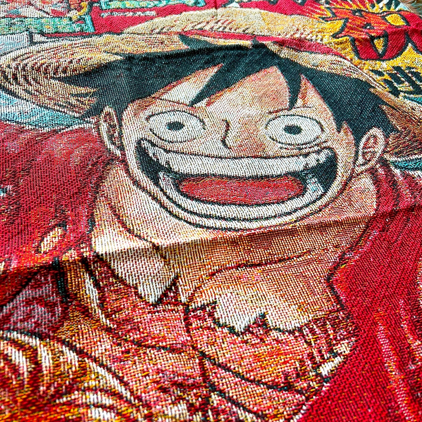 Close-up side view of a One Piece tapestry emphasizing vivid artwork and high-quality fabric details.