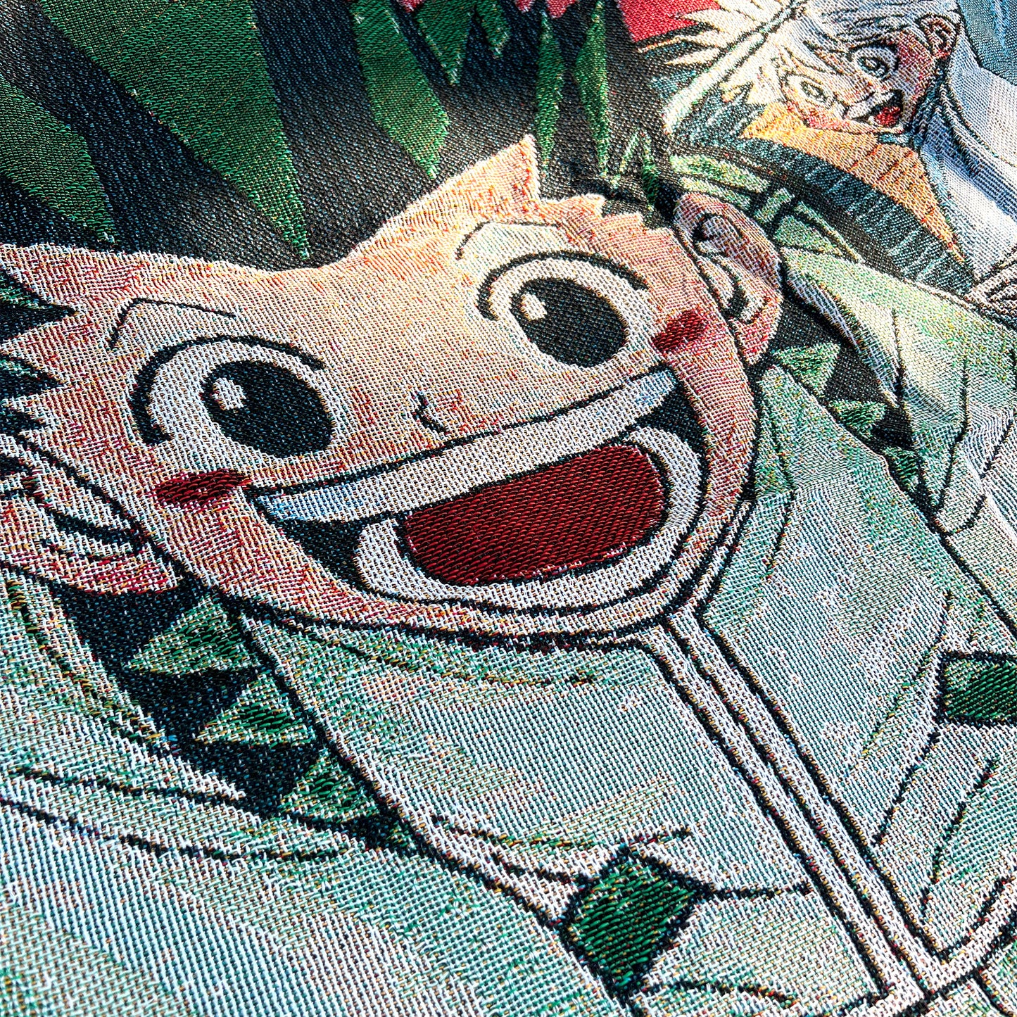 Close-up side view of a Hunter x Hunter tapestry highlighting intricate details and vivid colors of the anime design.
