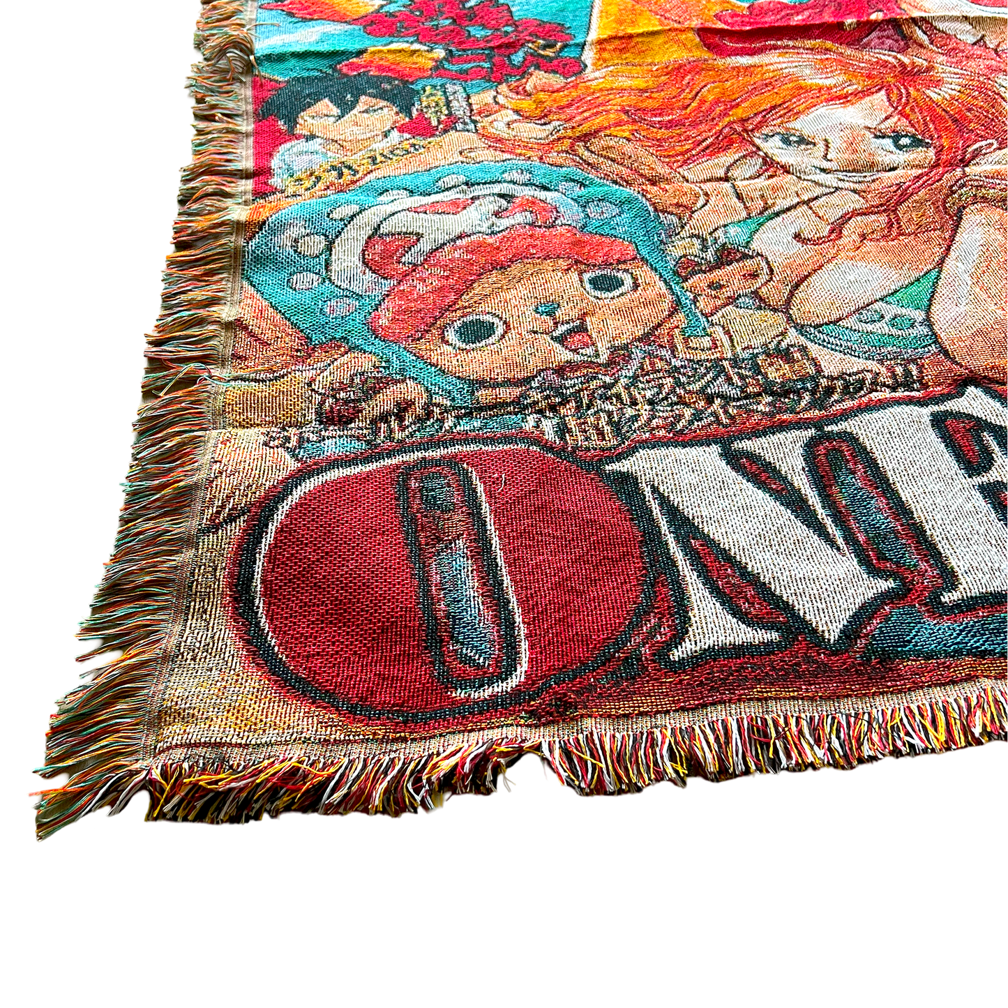 Close-up of a One Piece tapestry with a hand lifting the corner, highlighting the fine woven texture and premium craftsmanship.
