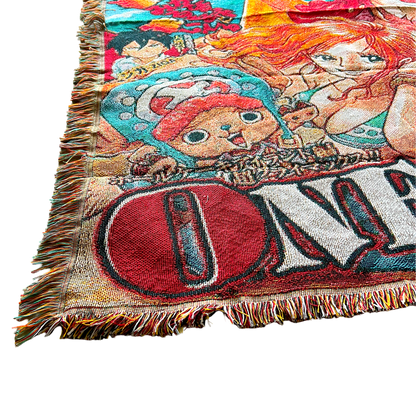 Close-up of a One Piece tapestry with a hand lifting the corner, highlighting the fine woven texture and premium craftsmanship.