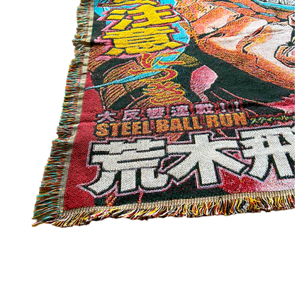 Close-up of a Gyro Zeppeli blanket with a hand lifting the corner, highlighting the plush texture and premium craftsmanship.